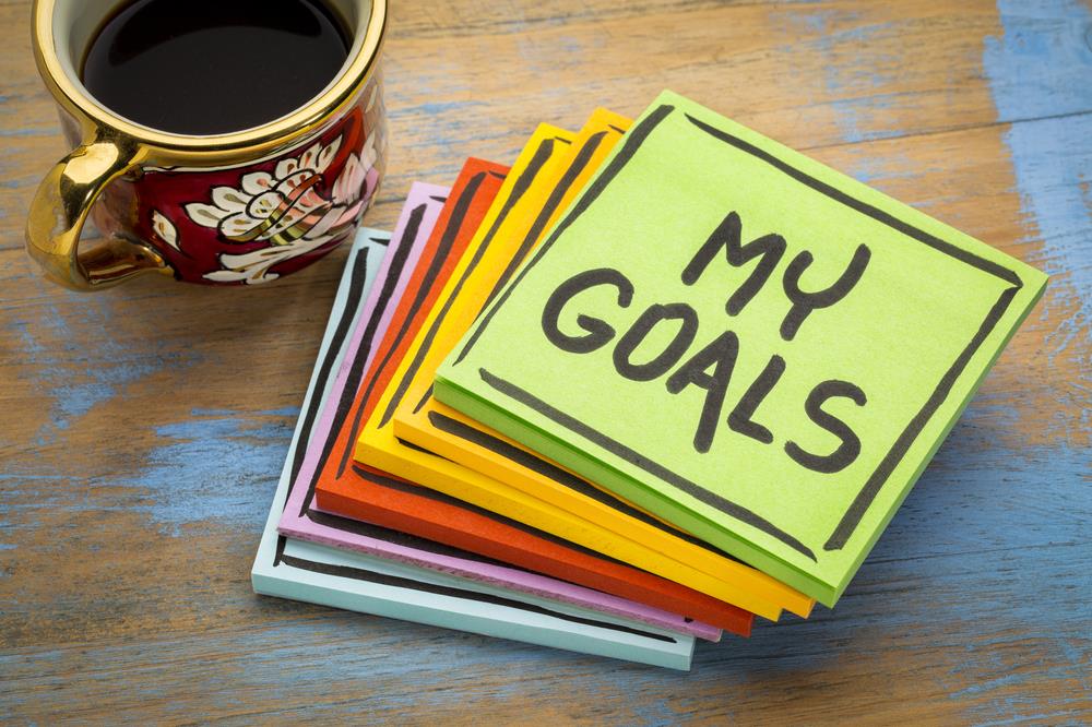 Stack of colorful sticky notes sitting on desk with 'My Goals' written in black marker