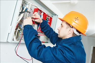 electrical and electronics installer working on a wiring system