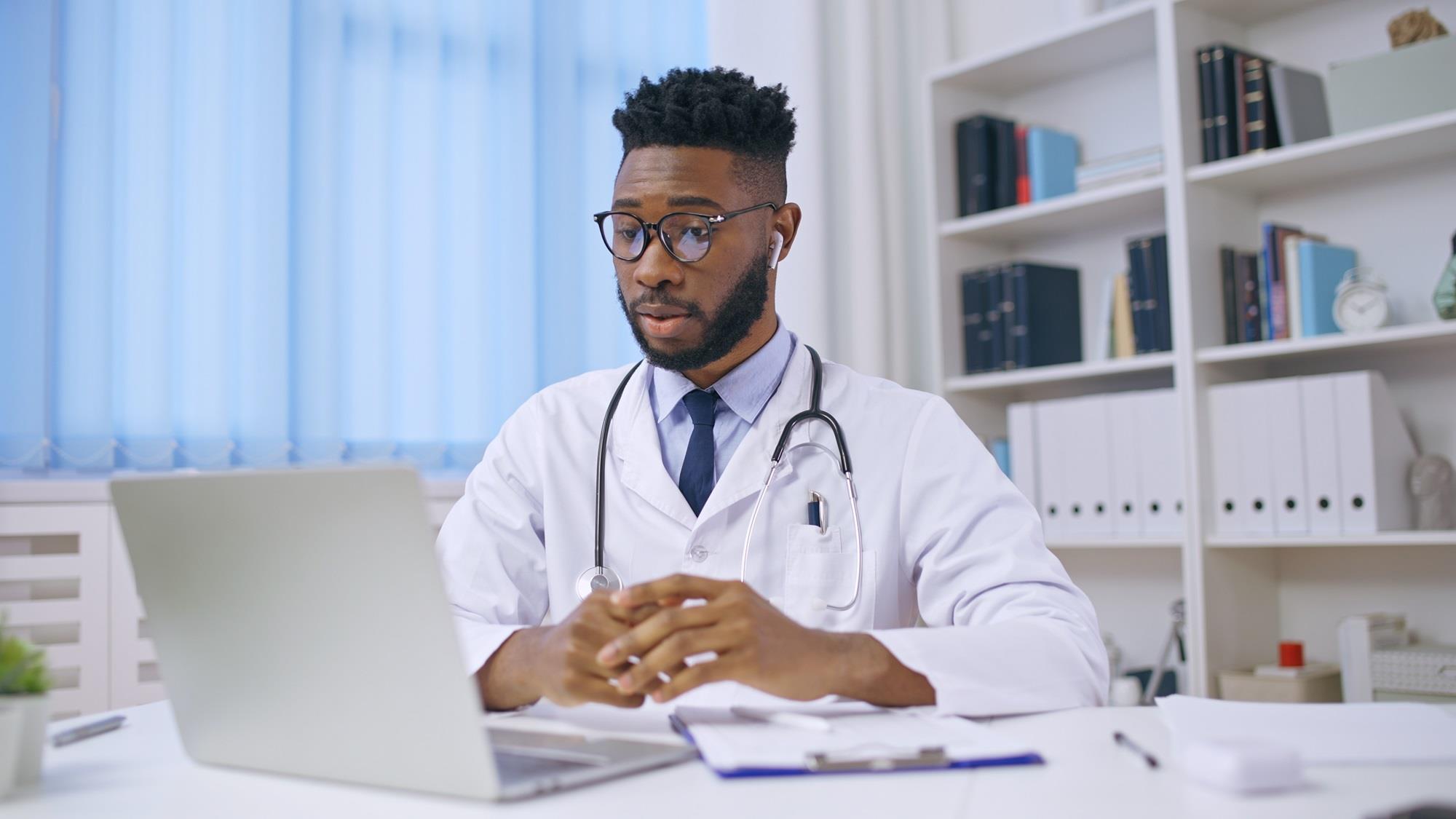 doctor meeting with a patient via his laptop