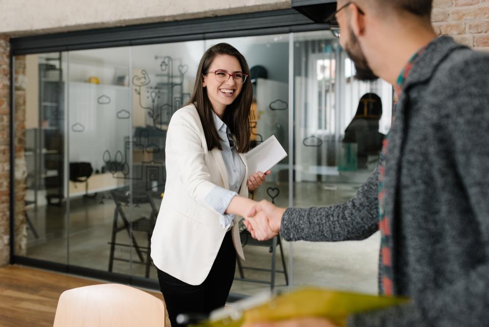 Woman in office shaking hands