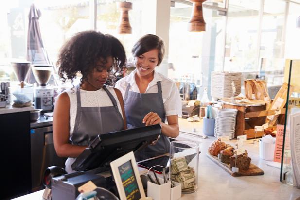 young employee learning how to use register