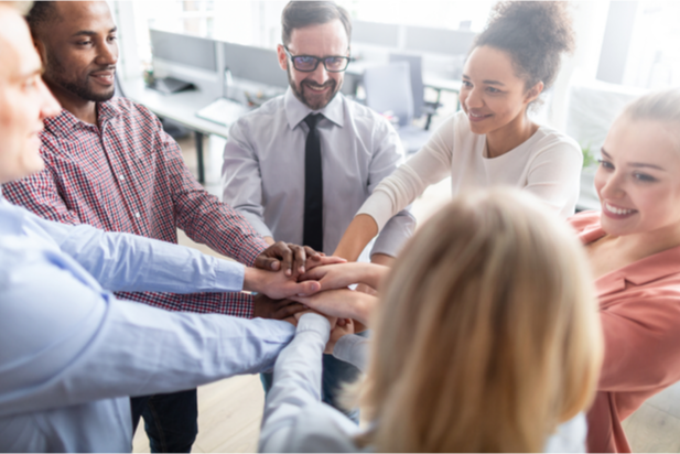 employees putting hands together