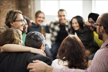 Happy team huddling in a circle