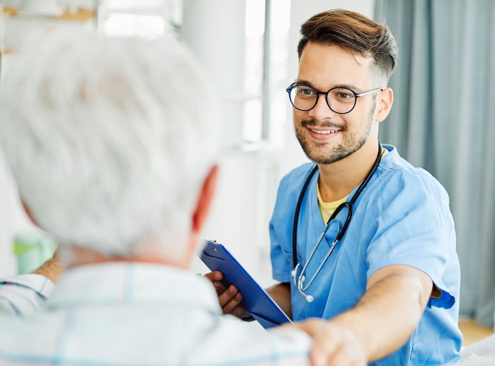 nurse assisting his elderly patient