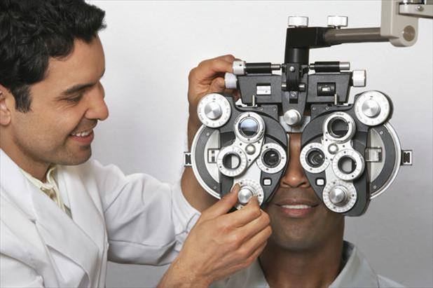 Optometrist performing an eye exam on a patient