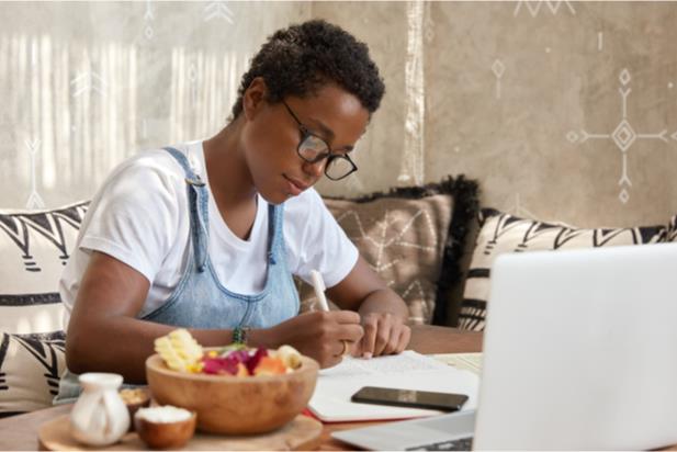 woman writing at laptop