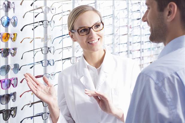 optician assisting a customer with selecting frames