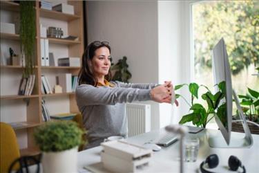 woman at desk with plants