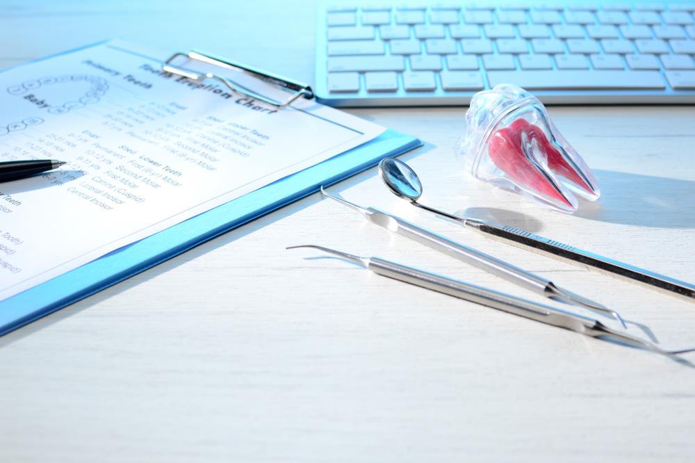 community dental health coordinator's desk with a chart, tools, etc. on it