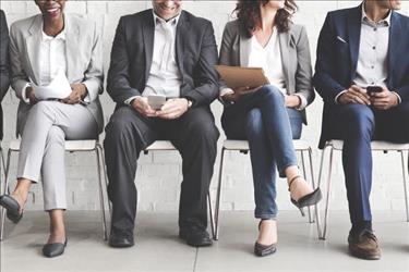 People sitting in chairs waiting to interview