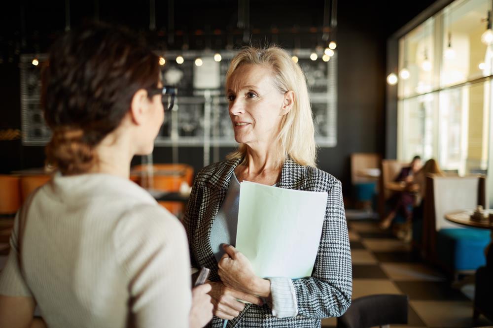 Restuarant manager speaking with employee