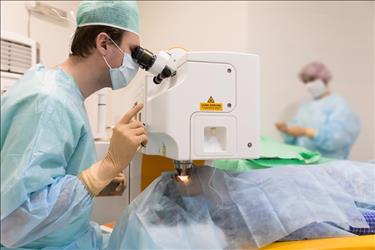 ophthalmic technician assisting ophthalmologist during surgery