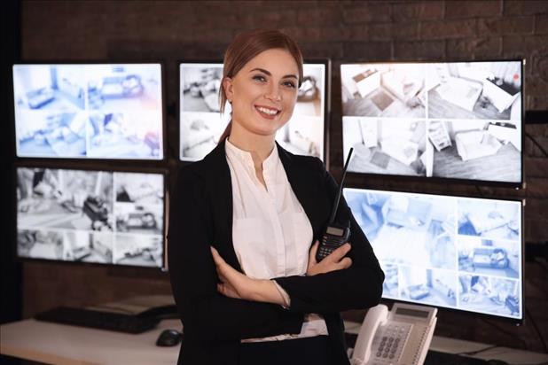 lead security guard in front of surveillance cameras