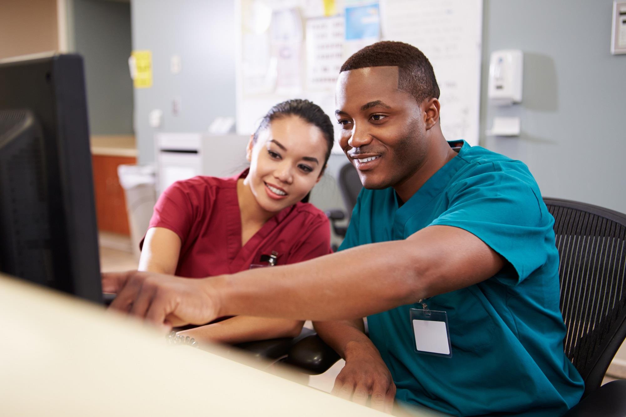 two medical team members at a clinic front desk
