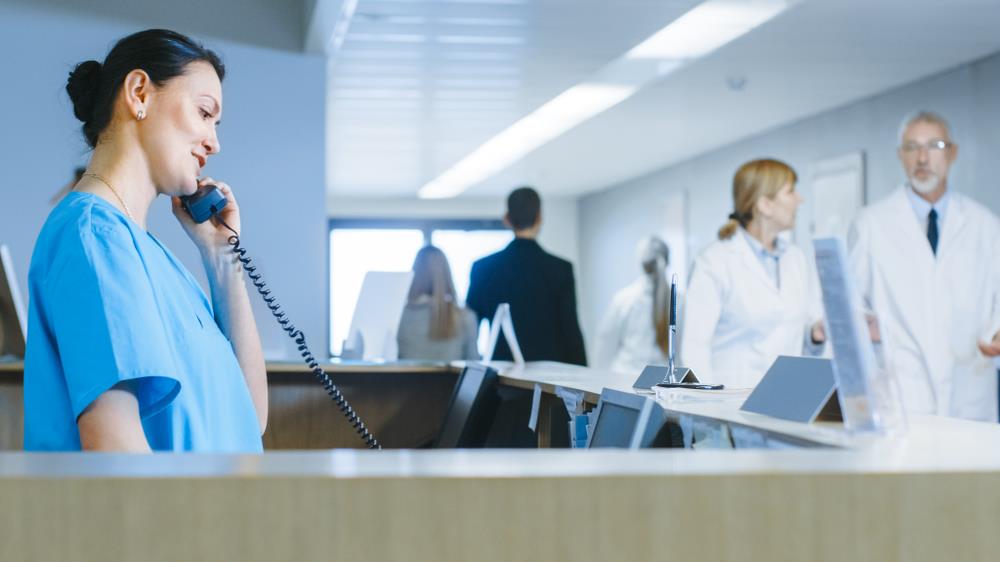 medical administrative specialist answering the phone in a hospital