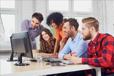 young employees looking at a computer