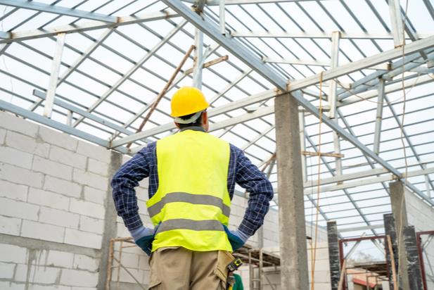 construction worker looking up at scaffolding