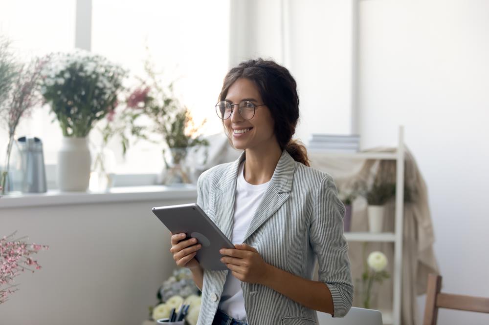 smiling professional holding a tablet