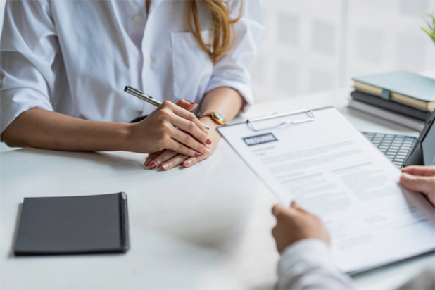 hiring manager reviewing a job seeker's resume during an interview