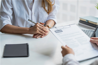 hiring manager reviewing a job seeker's resume during an interview