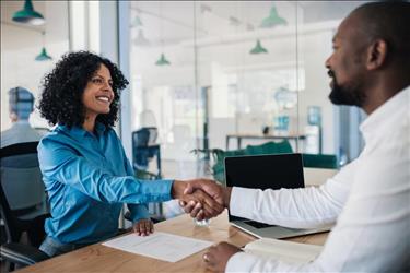 Woman shaking hands with interviewer