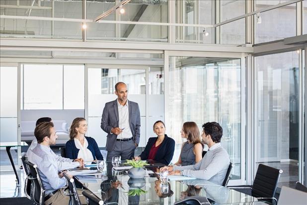 HR professional presenting to employees in corporate office