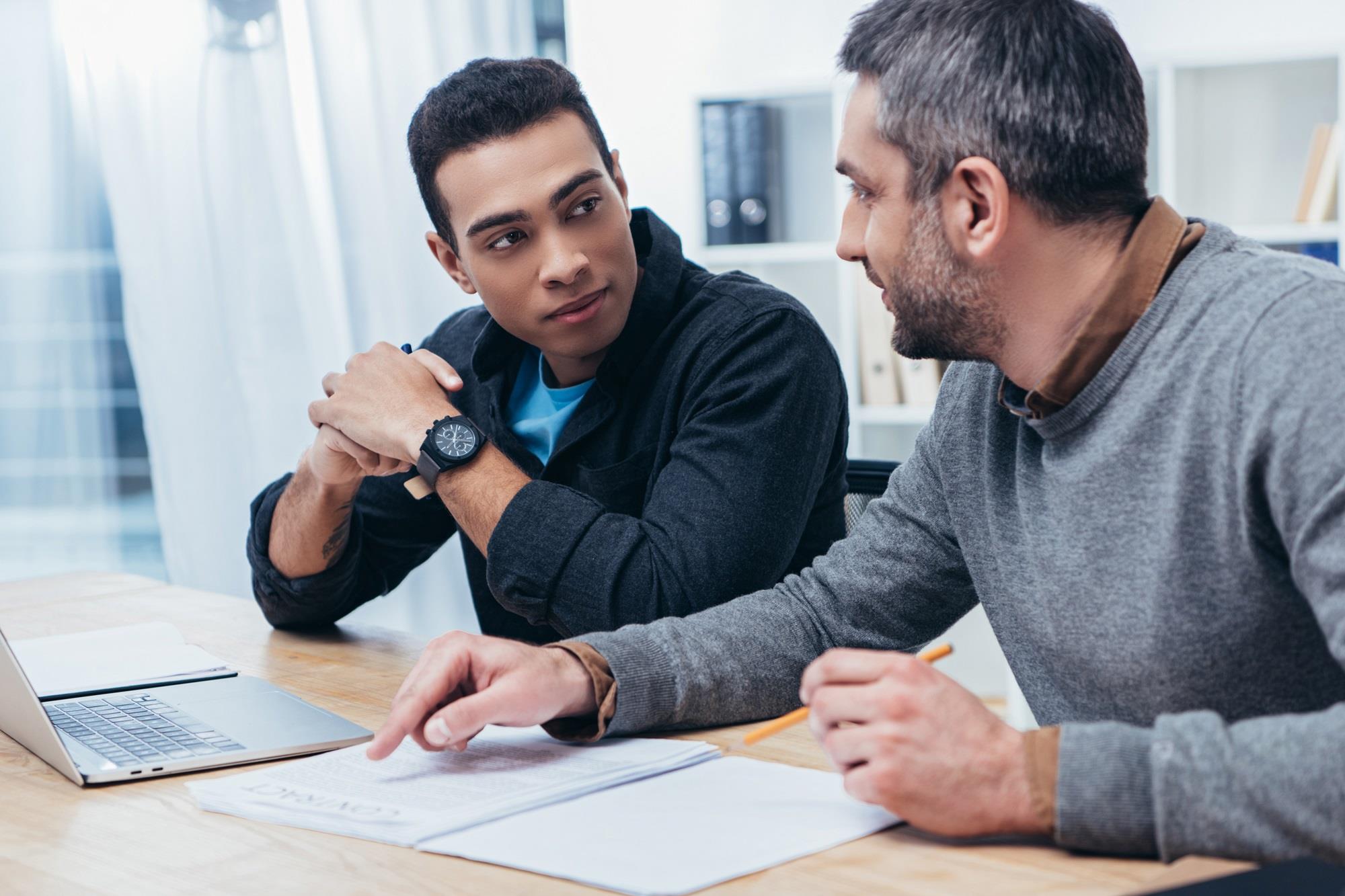 mentor and mentee reviewing a contract together