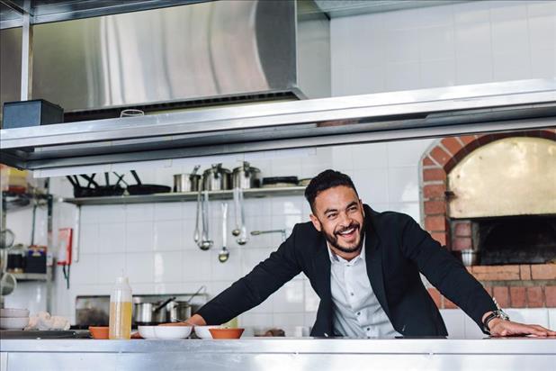 Owner smiling in his restaurant