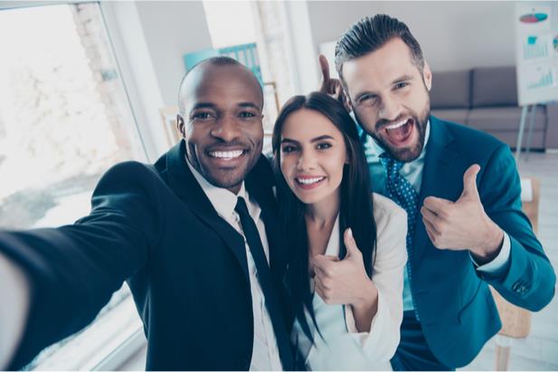 happy employees giving a thumbs up