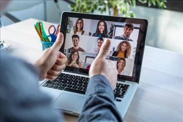 employee giving a thumbs up at remote team on laptop screen