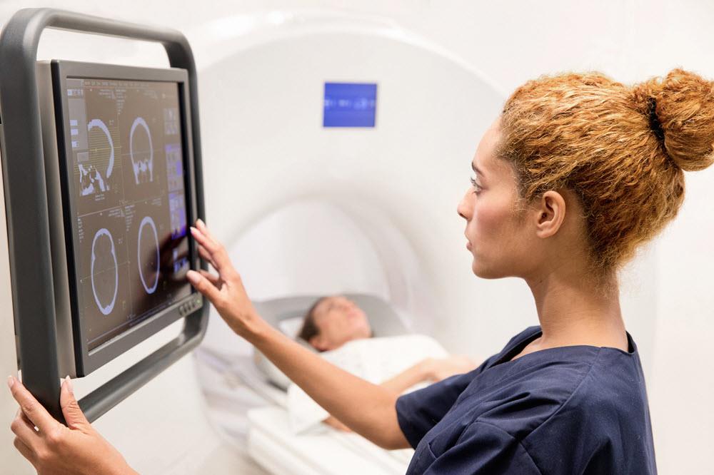 mri technician looking at images