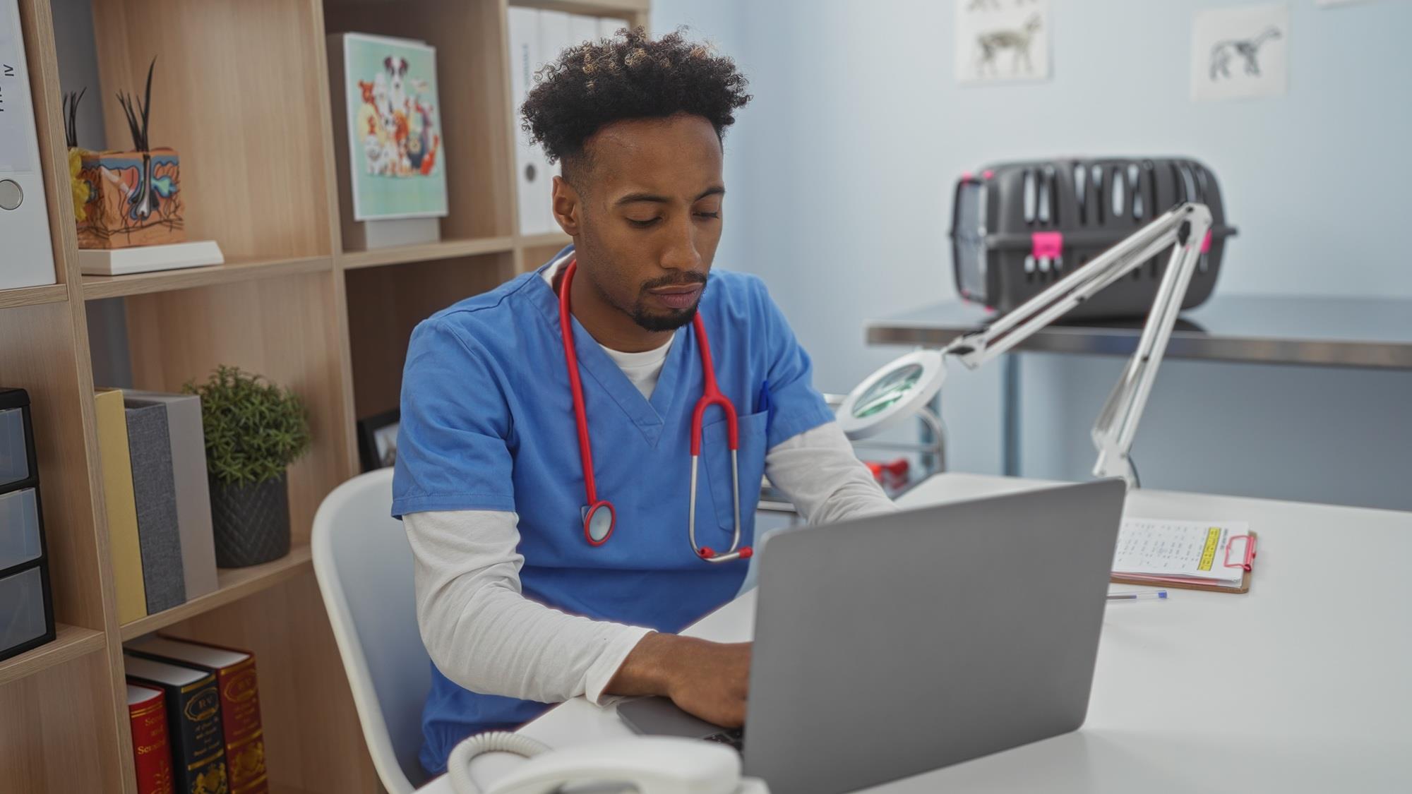 veterinarian typing on his laptop