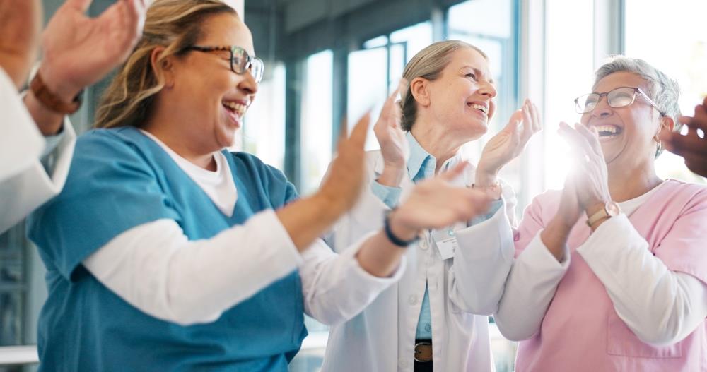 medical team clapping together