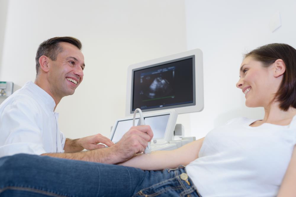 radiologic technologist performing a sonogram on a patient