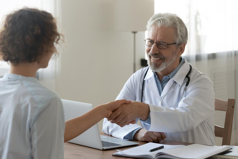 Doctor shaking hands in interview