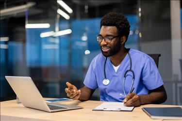 nurse taking notes during a telehealth appointment