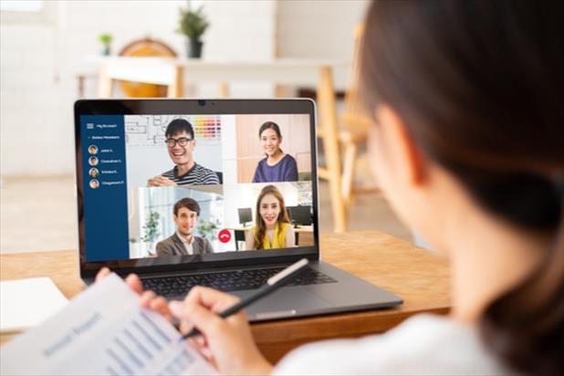 person looking at computer with remote team