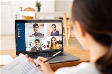 person looking at computer with remote team