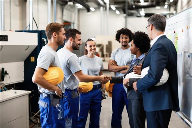 Manufacturing team meeting new colleague