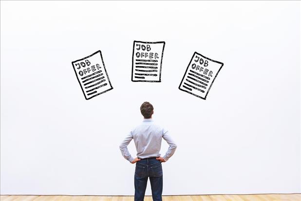 Man standing in front of graphic of three job offers