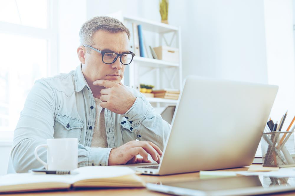 job seeker searching for jobs online on his laptop