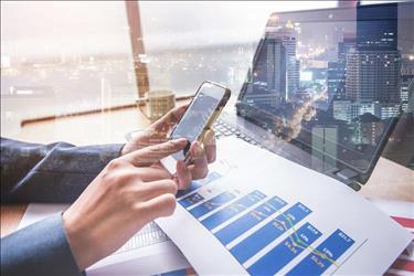 banker looking at charts on laptop