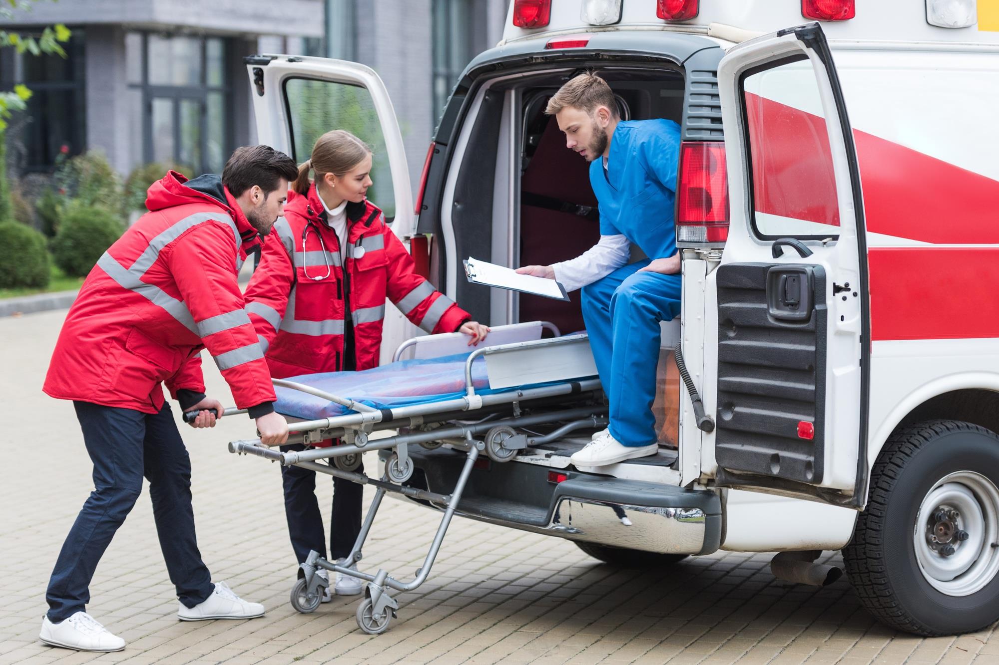 group of EMTs working in an ambulance
