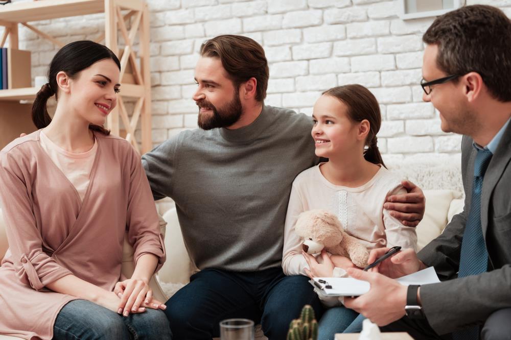 family social worker meeting with two parents and a child