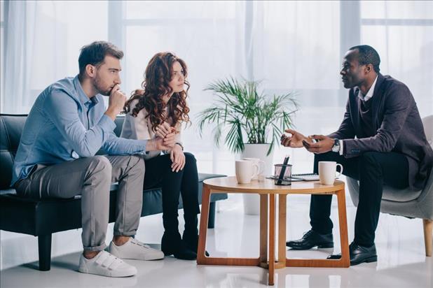 social worker meeting with two clients to provide crisis services