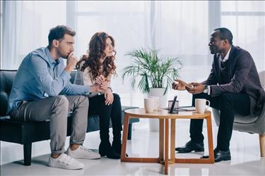 social worker meeting with two clients to provide crisis services