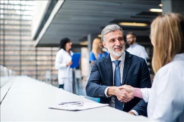 two medical professionals shaking hands