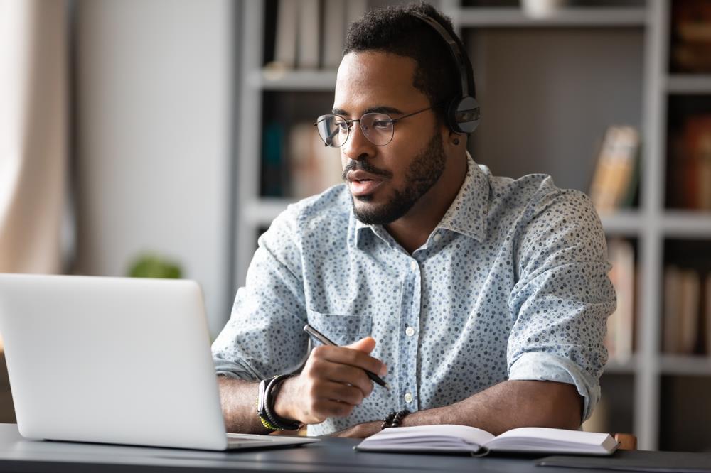 Man taking notes in video interview