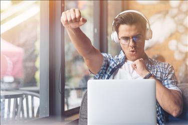 freelancer pumping his fist in the air with excitement