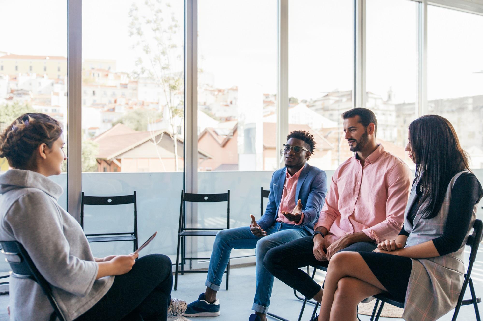 diverse group of employees sitting in training room